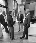 Black and white picture of Bob Brillante speaking with staff